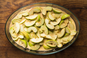 apple pie with cut apples sauce,  close up photo on a wooden table