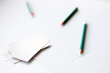 beginning drawing on a sheet of white paper and blank business cards