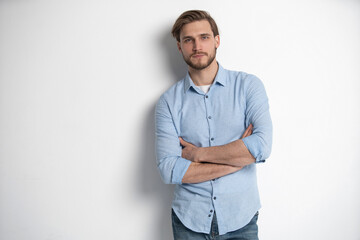 Portrait of a smart young man standing against white background.