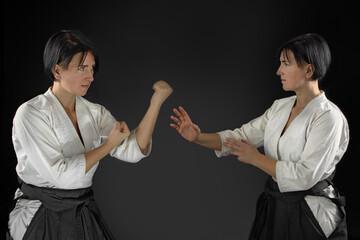 hand-to-hand man and woman fight on a black background. Asian vs European School. Training fight concept.