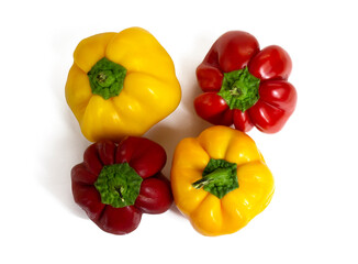 Yellow and red ribbed paprika peppers, isolated on white background, top view
