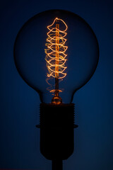 Retro Lamp on color background. Electric glow inside the lamp. Energy concept