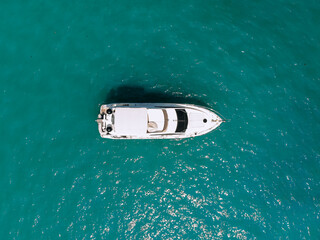 Adorable aerial top view photo of a laxury huge two-storey yach sailing across the deep blue sea