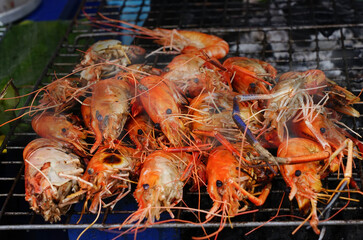 Grill time grill seafood snacks a charcoal shrimps street food traditional at  Thailand