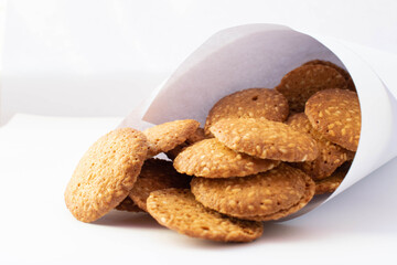 cookies with sesame seeds on a white plate for design
