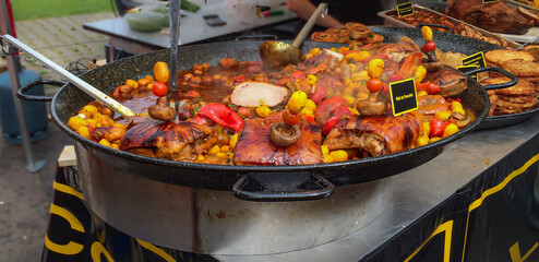 roast meat with vegetables in paella pan