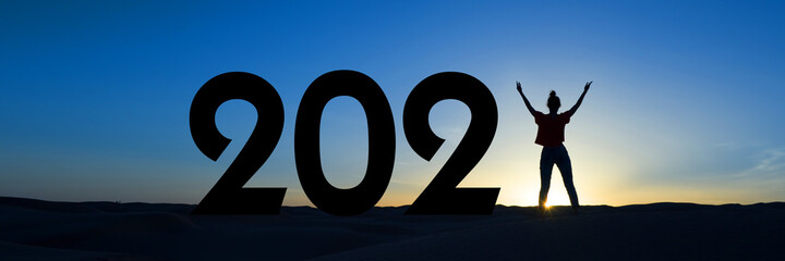 2021, silhouette of a woman standing in the sunrise, women empowerment, feminist new year holiday panoramic web banner