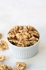 walnuts in bowl - on wooden background