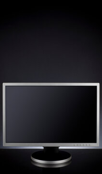 A widescreen computer screen on dark gradient studio background.