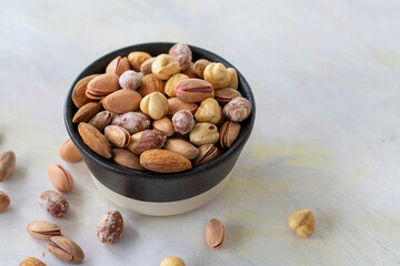 mixed nuts in bowl - on white background - copy space