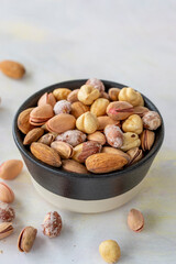 Naklejka na ściany i meble mixed nuts in bowl - on white background