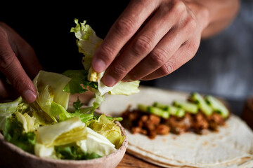 man preparing a durum or a burrito