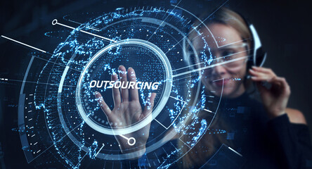 Business, Technology, Internet and network concept. Young business man writing word: Outsourcing