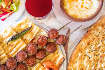 Turkish sausage also known as Sucuk. Grilled or barbecued Turkish sausage on the table in the Turkish restaurant.