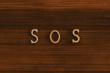 Sos noodle sign on wooden background