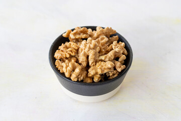 walnuts in bowl - on wooden background