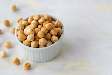 Hazelnuts in plate on white background - copy space