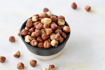 Hazelnuts in plate on white background