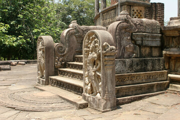 Fototapeta na wymiar Polonnaruwa Sri Lanka Ancient ruins Statues at entrance to shrine beside stairs