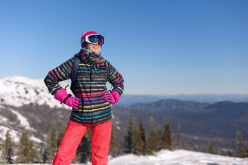 Fototapeta na wymiar Girl snowboarder in helmet and mask