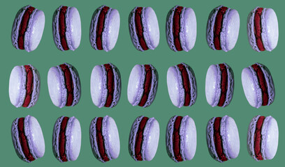 Purple pattern cakes macaroons on green  background