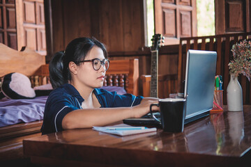 young woman .Working sitting on couch with laptop at home