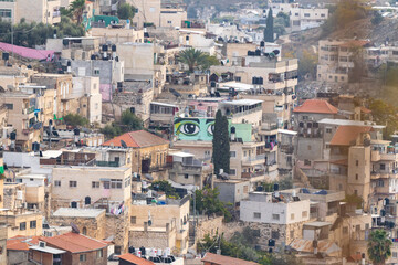 Fototapeta na wymiar View from the Dung Gate in the old city of Jerusalem to the valley with the Muslim suburb of Jerusalem - Silwan, in Israel
