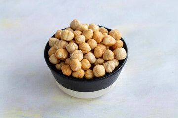 Hazelnuts in plate on white background