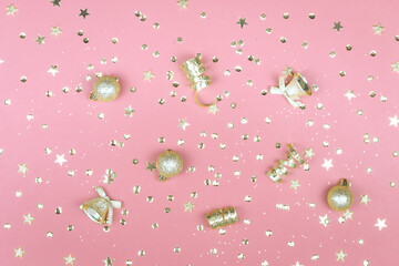 Pink background with glitter, golden stars and decorations. Sparkling texture. Festive backdrop for your projects.