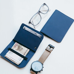 Blue slim purse for banknotes and holder for passport or id. Stylish handmade minimalistic accessories from eco leather. Near glasses and hand watches.