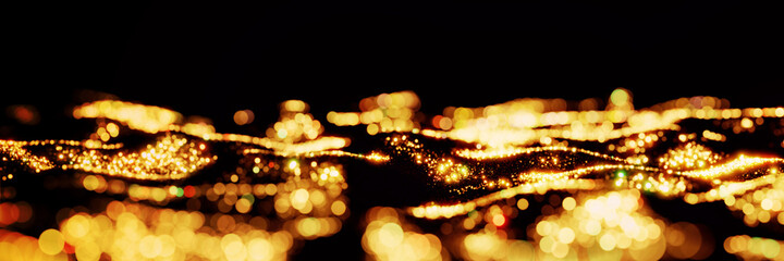 waves of twinkling golden glitter lit by a bright light, dynamic banner on black background