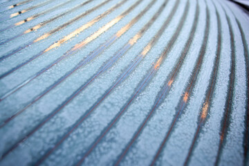 heated, ice-covered rear window of the car when defrosting on a winter morning