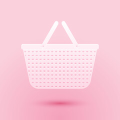 Paper cut Shopping basket icon isolated on pink background. Online buying concept. Delivery service sign. Shopping cart symbol. Paper art style. Vector.