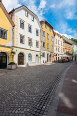 Old street paved with cobblestones in Ljubljana on sunny summer day