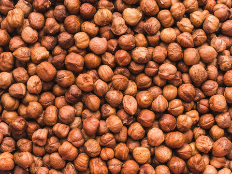 a lot of peeled hazelnuts without shells - food background