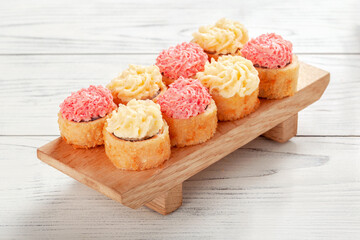 Set of Roll with cheese cap on wooden board.