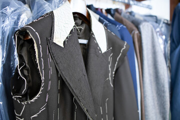 Male jacket basted on coat hunger in the tailor's shop