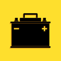 Black Car battery icon isolated on yellow background. Accumulator battery energy power and electricity accumulator battery. Long shadow style. Vector.