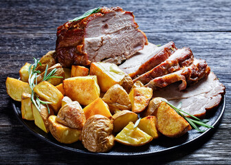 Whole roasted pork loin with baked potato wedges