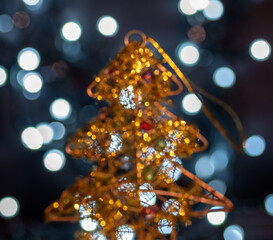 Christmas background - golden toy fir tree and bokeh.