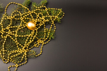Background with a spruce branch, New Year's beads. Congratulatory Christmas background with place for text.