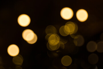 Defocused garland lights, Bokeh effect. Sparkling and fairy background. Christmas and New Year holidays concept.