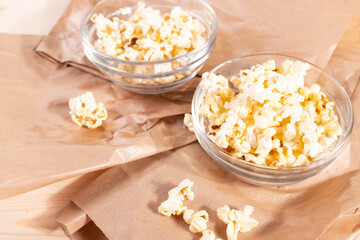 crispy golden ready to eat popcorn in a glass bowl. close up shot. 