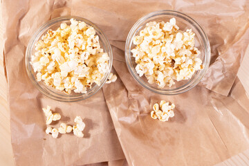 crispy golden ready to eat popcorn in a glass bowl. close up shot. 