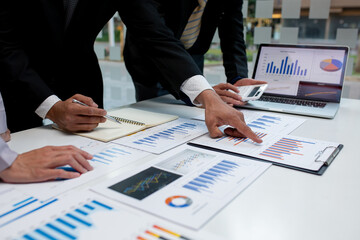 Team of business people working together in the meeting room office,
teamwork background charts and graphs banner, double exposure successful teamwork,business planning concept.
