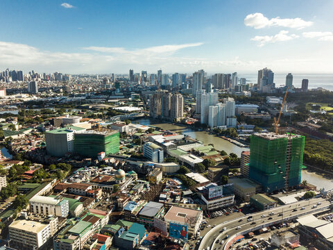 Manila, Philippines -The Pasig river cuts through the sprawling megacity. Distant skylines of Makati and Southern Manila in the background.