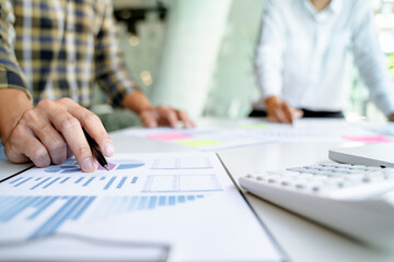 Business Startup team discussing on data report documents at modern workplace..