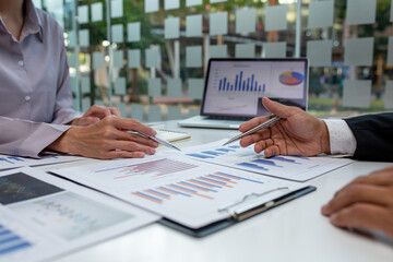 Team of business people working together in the meeting room office,
teamwork background charts and graphs banner, double exposure successful teamwork,business planning concept.
