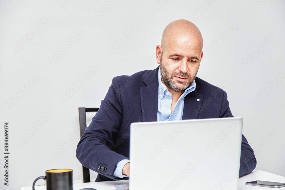 Wall mural a self-employed businessman working from home with a laptop