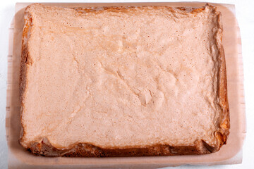 Step by step recipe of sponge cake. Step 7. Prepared sponge cake is cooling down on the wooden board. Top view